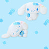 Two Cinnamoroll plush toys with blue flower accents and embroidered blue facial features, shown on a light blue background with matching blue flower motifs.