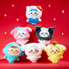 Six cute plush character toys arranged on red display blocks against a red background with white star graphics. The characters wear colorful hooded outfits in blue, pink, black, aqua, white, and yellow, each with a smiling face and rosy cheeks.