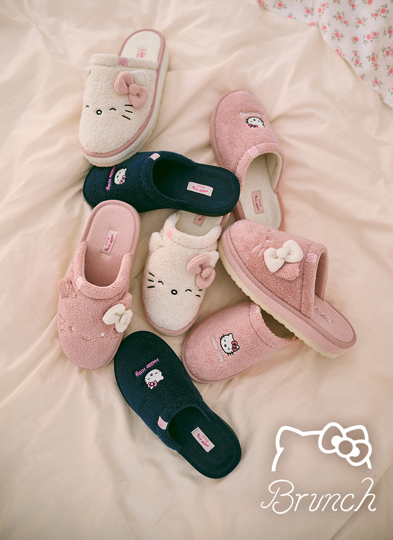 Set of Hello Kitty slippers on a soft surface with 'Brunch' brand logo.