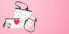 Hello Kitty x LeSportsac product set on a pink background.