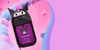 A Touchland Power Mist bottle with a Kuromi character design, set against a vibrant pink and purple background with abstract pastel shapes.