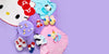 Collection of colorful Sanrio Characters shoes and accessories on a purple background.