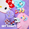 Collection of colorful slippers and accessories on a purple surface with 'GET COMFY' text.