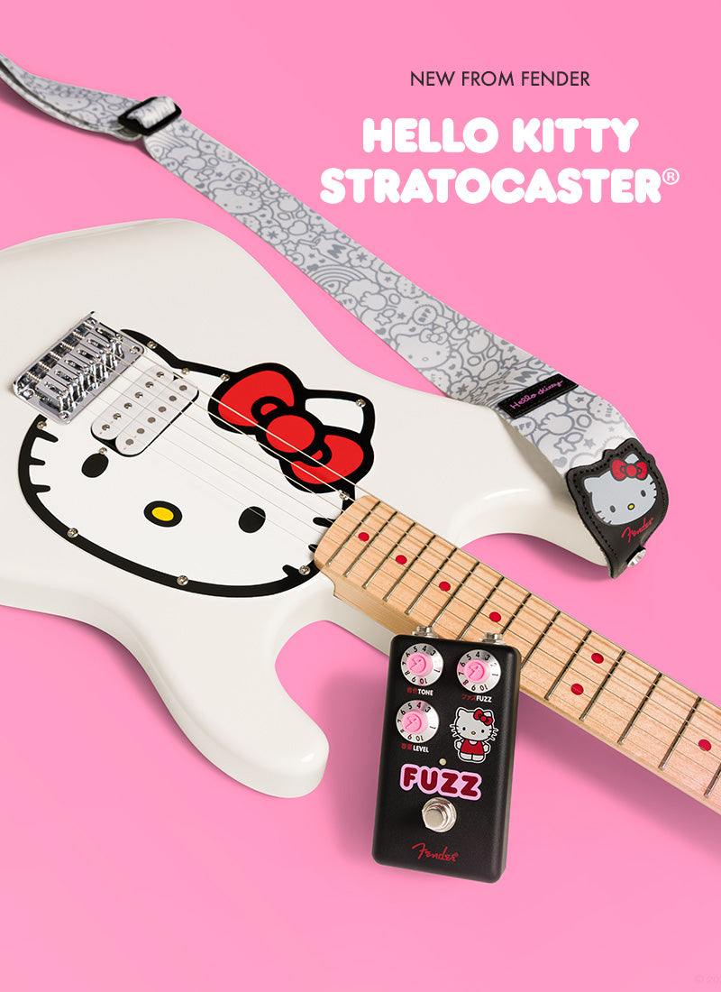Fender Hello Kitty Stratocaster guitar with a fuzz pedal on a pink background